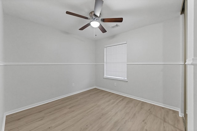 empty room with ceiling fan and light hardwood / wood-style flooring