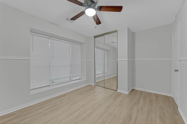 unfurnished bedroom with a closet, ceiling fan, and light wood-type flooring