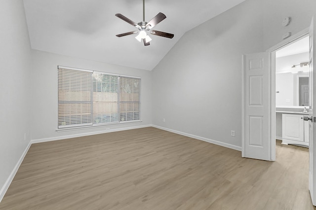 unfurnished room featuring ceiling fan, vaulted ceiling, and light hardwood / wood-style flooring