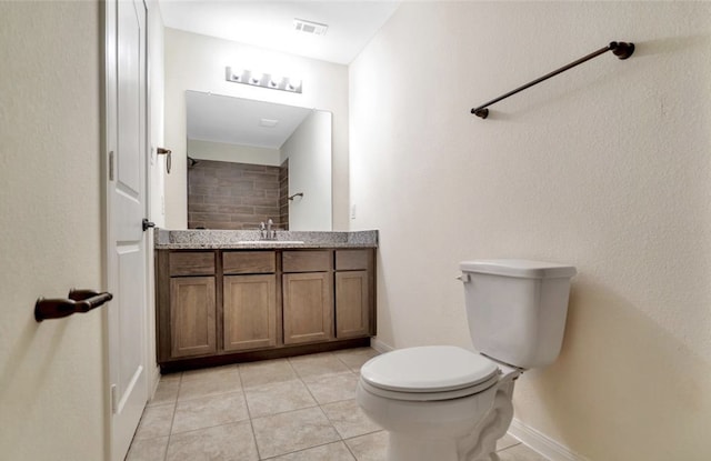 bathroom featuring vanity, tile patterned flooring, and toilet