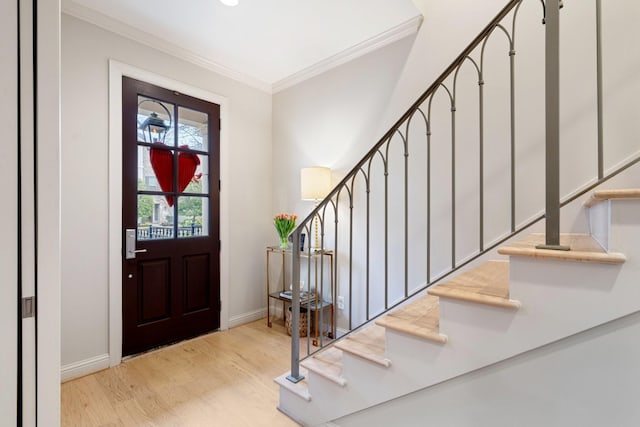 foyer featuring light hardwood / wood-style flooring and ornamental molding