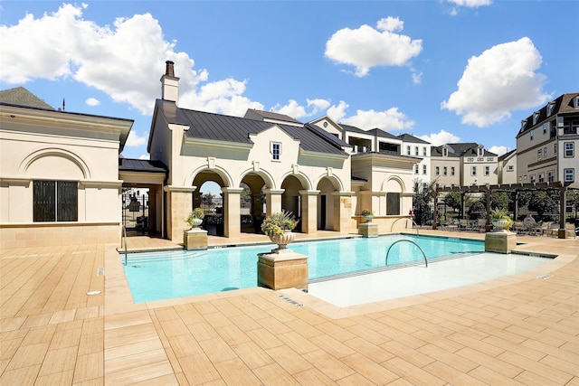 view of swimming pool featuring a patio area