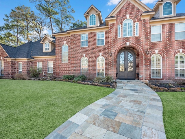 view of front facade featuring a front yard and french doors