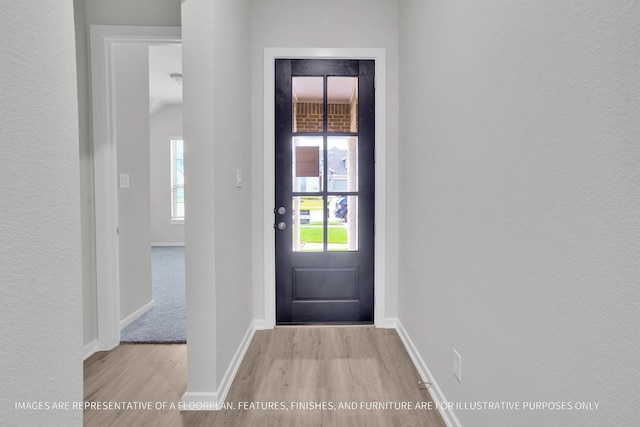 doorway to outside with light wood-type flooring