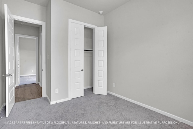 unfurnished bedroom with carpet floors, a closet, and baseboards