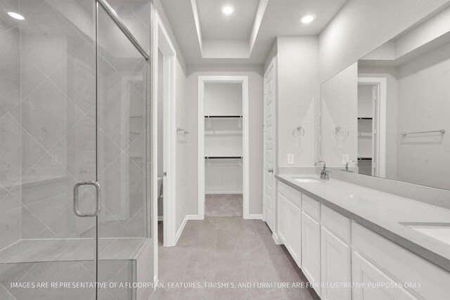 bathroom featuring vanity, tile patterned flooring, and walk in shower