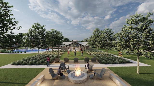 view of home's community with a gazebo, a yard, and an outdoor fire pit