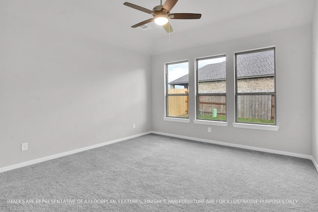 spare room with ceiling fan, carpet, visible vents, and baseboards