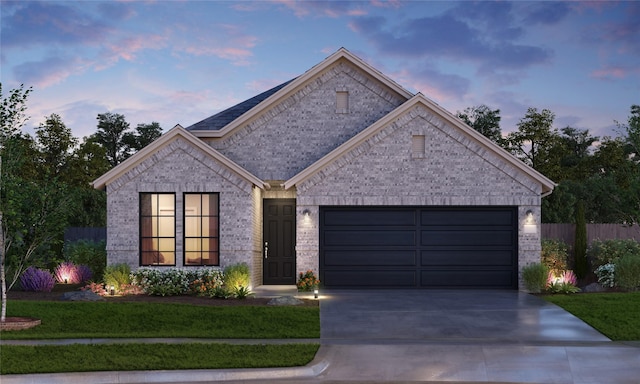 view of front facade featuring a garage and a lawn