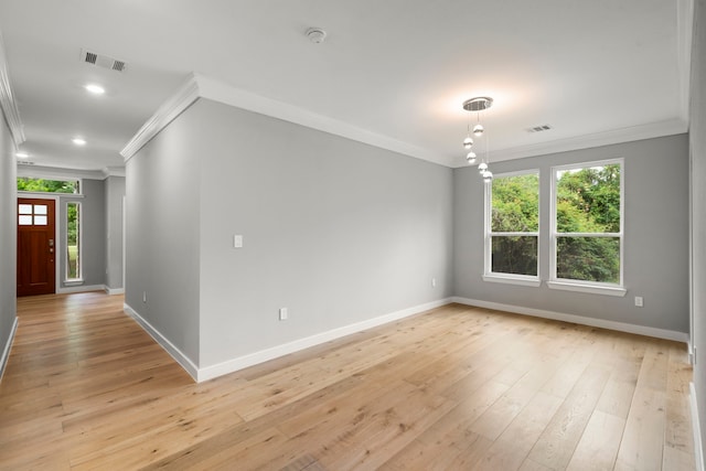 interior space with crown molding and light hardwood / wood-style floors