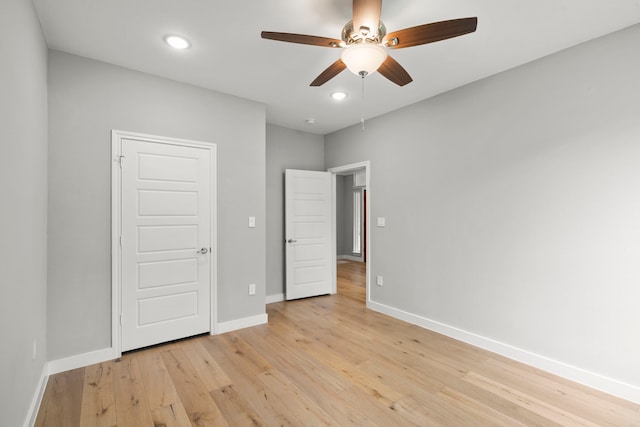 unfurnished bedroom with ceiling fan and light hardwood / wood-style floors