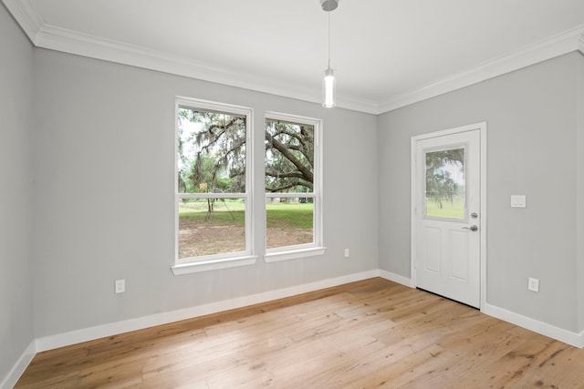 entrance foyer featuring ornamental molding and light hardwood / wood-style flooring