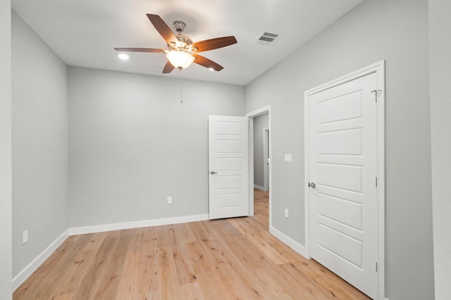 empty room featuring ceiling fan and light wood-type flooring