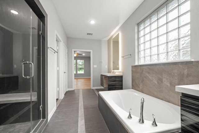 bathroom featuring tile patterned floors, vanity, and plus walk in shower