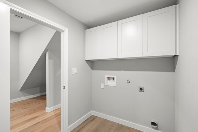 laundry area featuring cabinets, hookup for a gas dryer, washer hookup, hookup for an electric dryer, and light hardwood / wood-style flooring