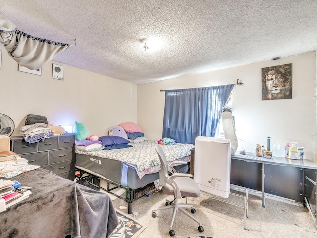 bedroom featuring a textured ceiling and carpet flooring