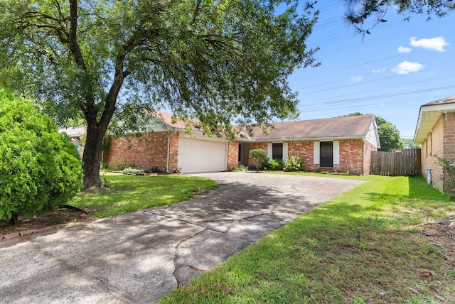 ranch-style house featuring a garage and a front yard