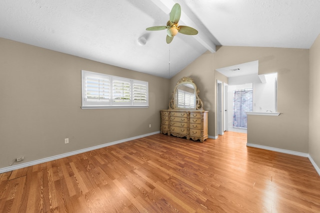 unfurnished bedroom featuring vaulted ceiling with beams, a textured ceiling, ceiling fan, and light wood-type flooring