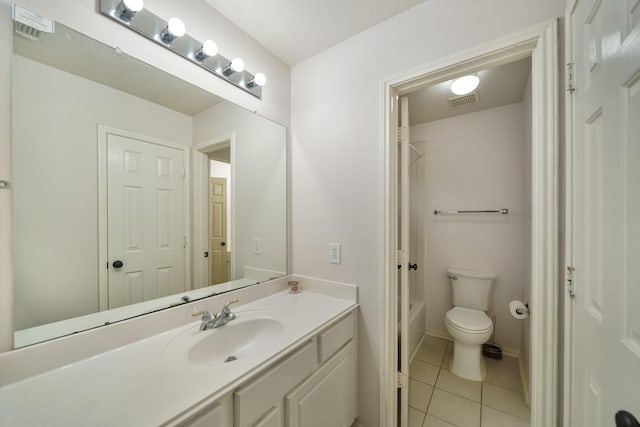 bathroom featuring vanity, tile patterned floors, and toilet