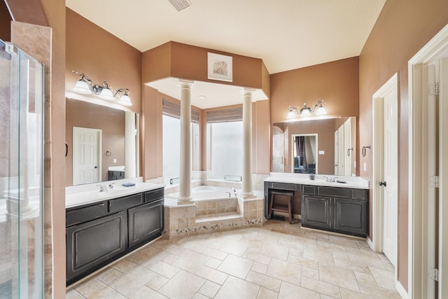 bathroom featuring decorative columns, vanity, and independent shower and bath