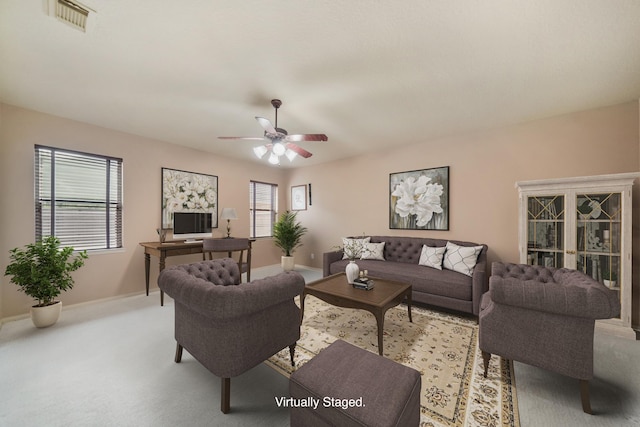 living room with light colored carpet and ceiling fan