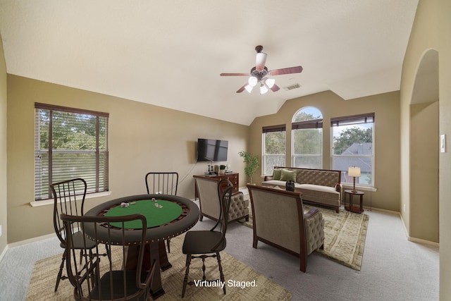 dining area with vaulted ceiling, light colored carpet, and ceiling fan