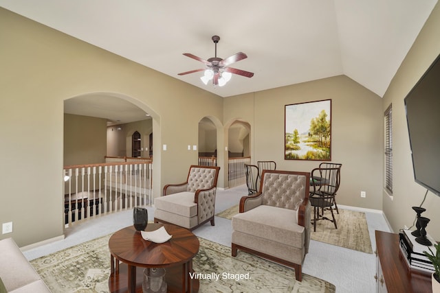 living room with light carpet, vaulted ceiling, and ceiling fan