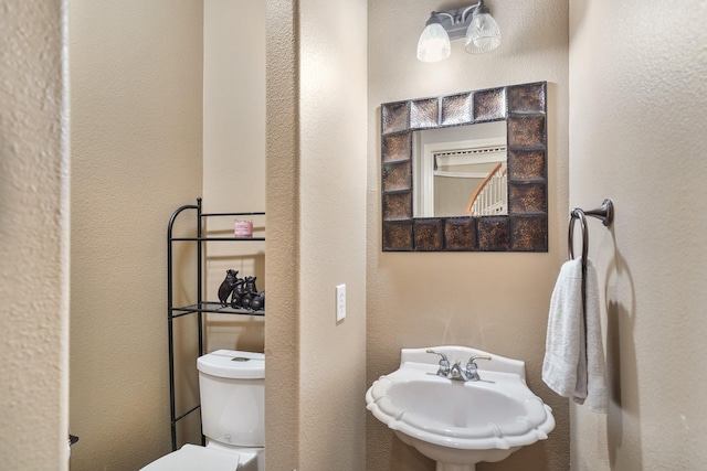 bathroom featuring toilet and sink