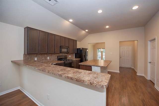 kitchen featuring lofted ceiling, dark brown cabinets, black appliances, and kitchen peninsula