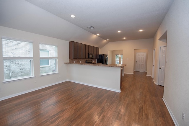 kitchen featuring dark brown cabinetry, vaulted ceiling, dark hardwood / wood-style flooring, kitchen peninsula, and black appliances