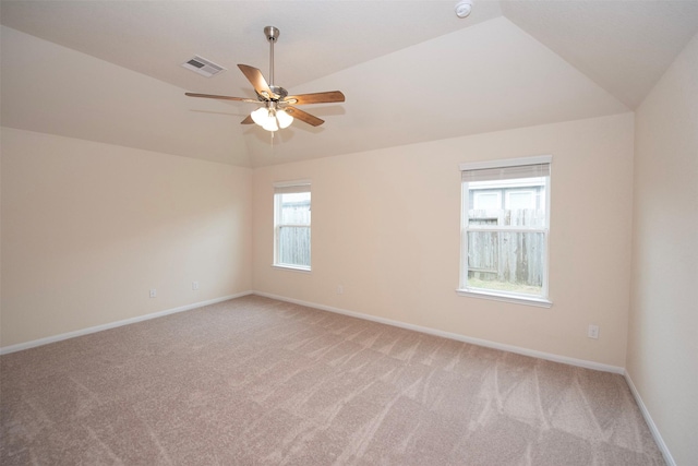 carpeted empty room with ceiling fan and vaulted ceiling