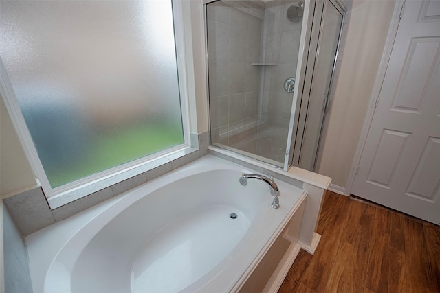 bathroom featuring independent shower and bath and wood-type flooring