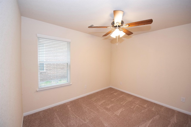 carpeted empty room featuring plenty of natural light and ceiling fan