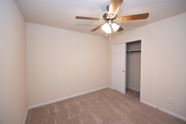 unfurnished bedroom featuring carpet, ceiling fan, and a closet