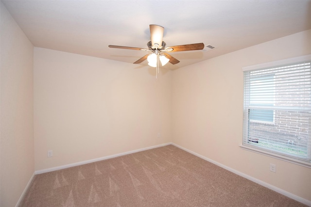 empty room featuring ceiling fan and carpet flooring