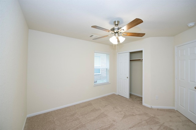 unfurnished bedroom with ceiling fan, light colored carpet, and a closet