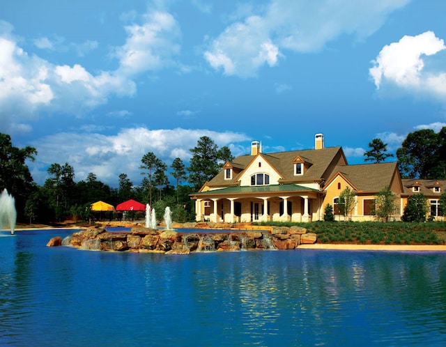 view of swimming pool featuring a water view