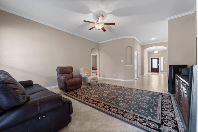 living room with light tile patterned floors, ornamental molding, and ceiling fan