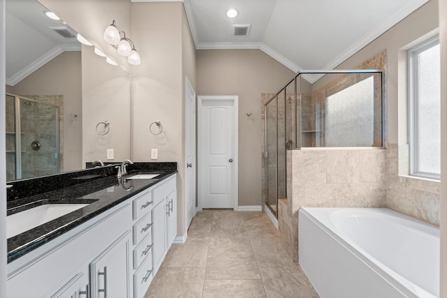 bathroom with crown molding, vanity, vaulted ceiling, and a wealth of natural light