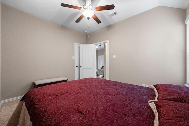 carpeted bedroom featuring lofted ceiling and ceiling fan