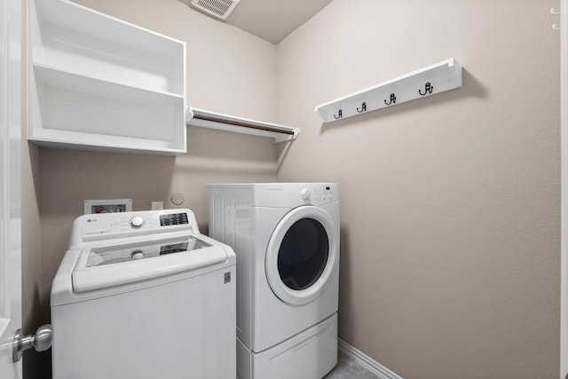 laundry area featuring washing machine and clothes dryer