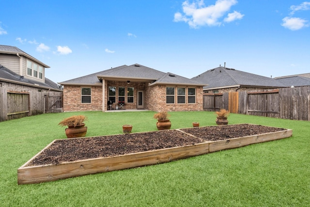 rear view of property featuring a lawn