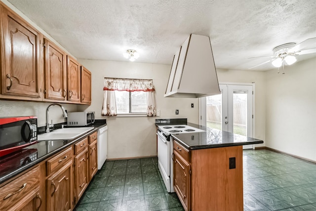 kitchen featuring white appliances, island range hood, sink, and a wealth of natural light