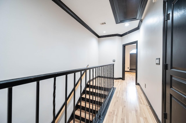 hall with crown molding and light hardwood / wood-style flooring