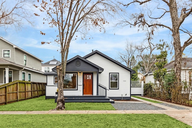 bungalow-style house featuring a front lawn