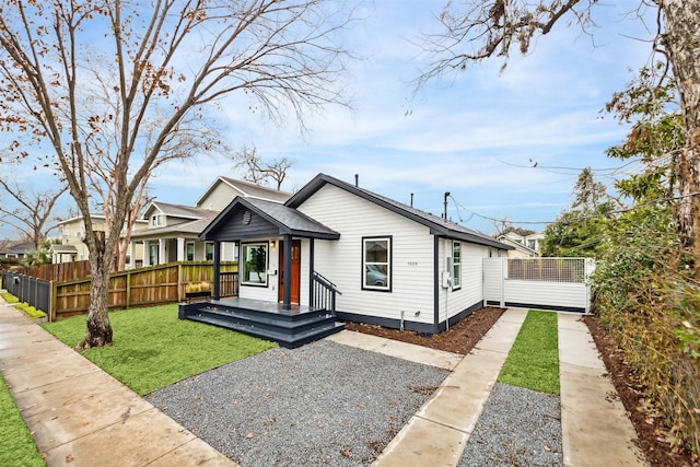 bungalow-style home featuring a front lawn