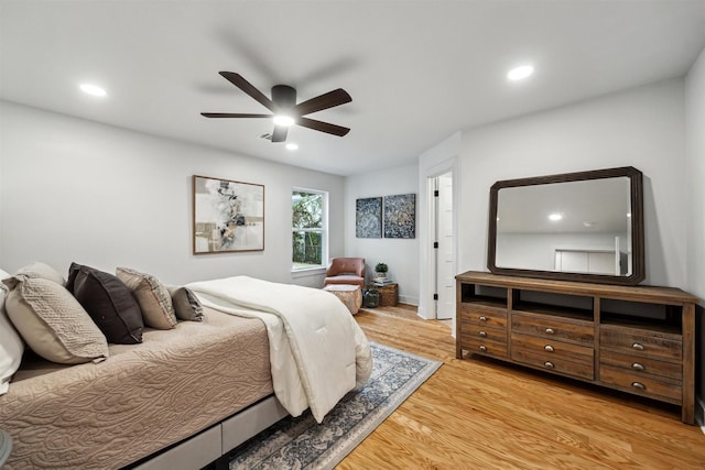 bedroom with light hardwood / wood-style floors and ceiling fan