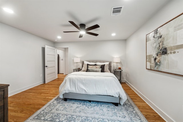 bedroom with ceiling fan and light hardwood / wood-style flooring