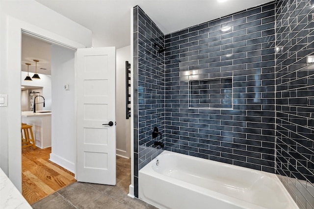 bathroom with tiled shower / bath combo and hardwood / wood-style flooring