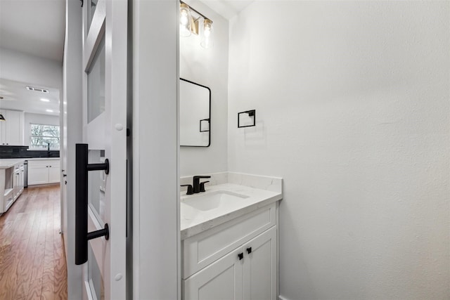 bathroom featuring vanity and wood-type flooring